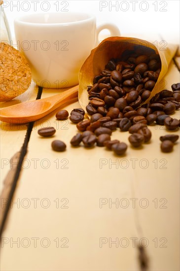 Espresso coffee and beans on a paper cone cornucopia over white background