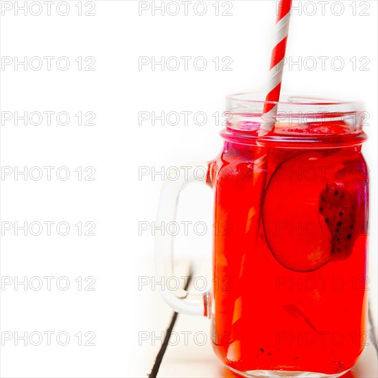 Fresh fruit punch refreshing summer drink over white rustic wood table