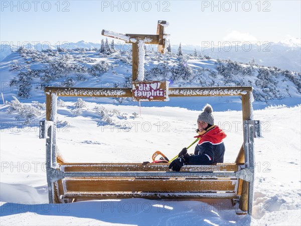 Tourist enjoying the view of snow-covered peaks from the mountain station at Lawinenstein