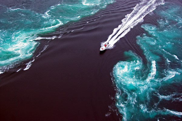 Powerboat rides into the eddies of a tidal stream