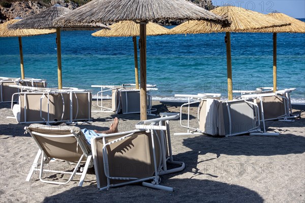 Inverted parasols and sun loungers on the beach