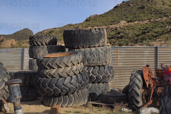 Stacked tyres from agricultural machinery and tractors in scrap yards