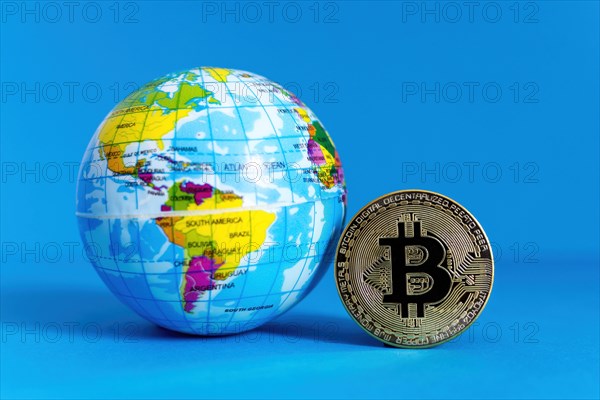 Bitcoin BTC crypto currency gold coin and Earth globe