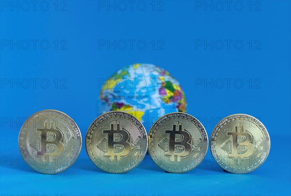 Bitcoin BTC crypto currency gold coins and Earth globe