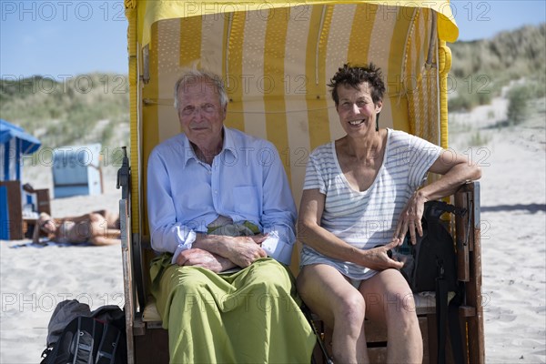 Tourists sitting in a beach chair