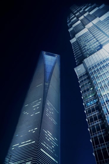Shanghai pudong world financial center and jin mao tower illuminated by night