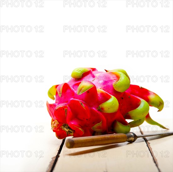 Fresh thai purple dragon fruit over white rustic table