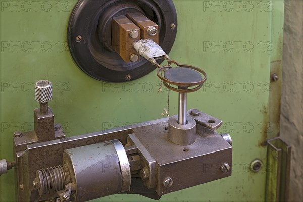 Copper coil of an induction hardening machine in a historical valve factory