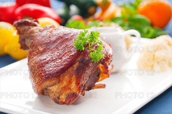 Original German BBQ pork knuckle served with mashed potatoes and sauerkraut