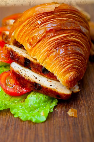 Savory croissant brioche bread with chicken breast and vegetable rustic style