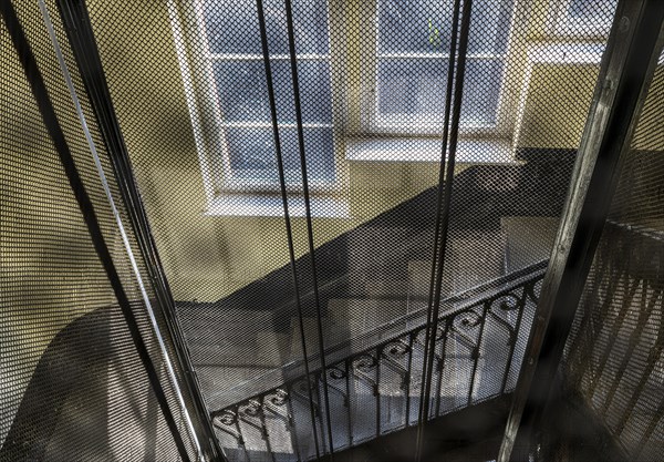 Protective grating on a historic lift shaft in an old factory