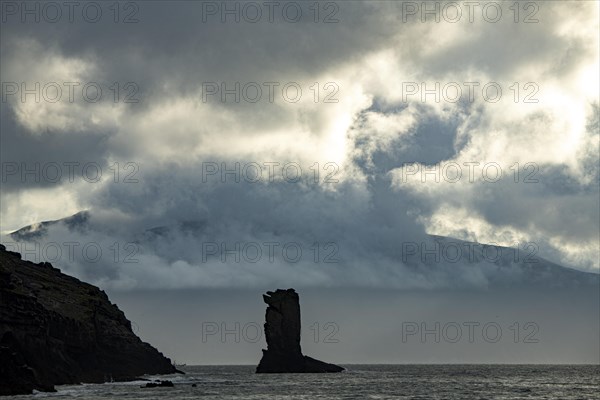 North Atlantic with rock needle and cloudy sky