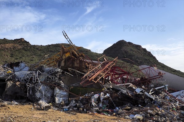 Scrap piles in front of mountains