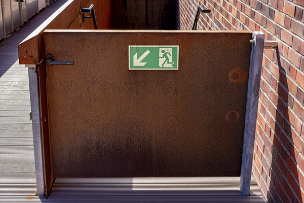 Emergency exit on a rusty steel door