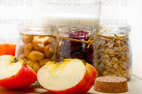 Healthy breakfast ingredients milk oat cashew nuts dried cramberry craisinns