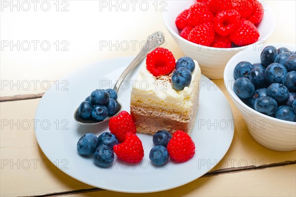 Fresh homemade raspberry and blueberry cream cake