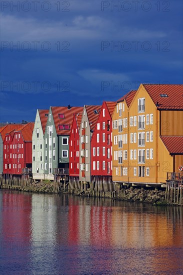 Wooden houses on stilts reflected in a body of water