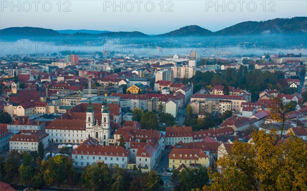 Cityscape of Graz with Mur river and Mariahilfer church