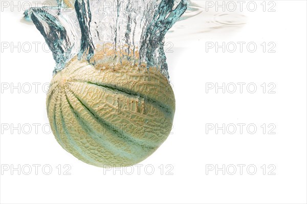 Cantaloupe melon splash and sinking isolated against white background