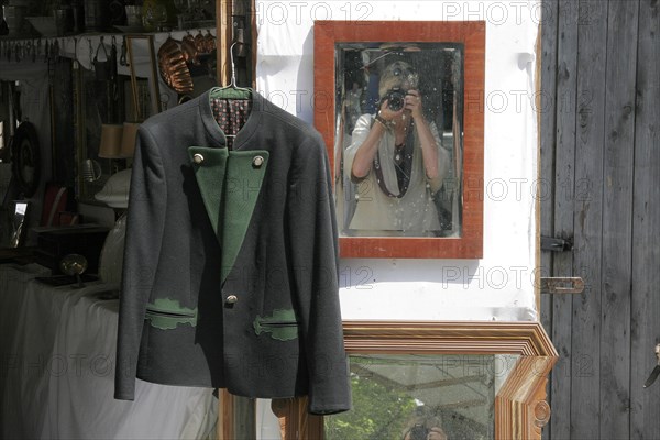 Traditional traditional costume jacket hangs on hanger for sale at flea market