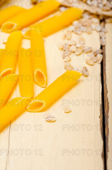 Short Italian pasta penne with durum wheat grains