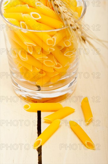 Short Italian pasta penne with durum wheat grains