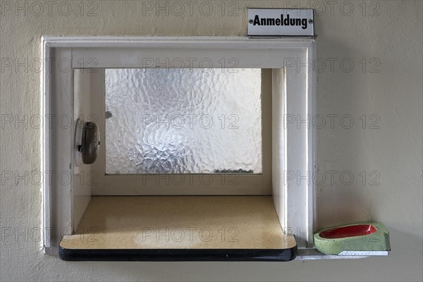 Registration window with ashtray for waiting customers in a former valve factory today