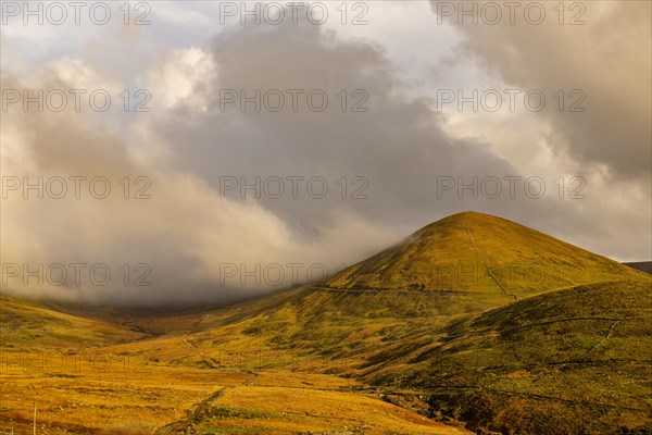 Autumn mountain landscape with cloudy sky