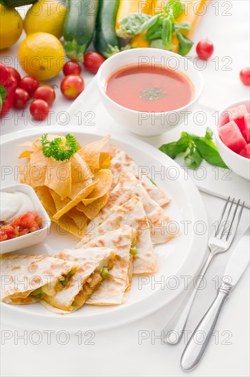 Original Mexican quesadilla de pollo with nachos served with gazpacho soup and watermelon