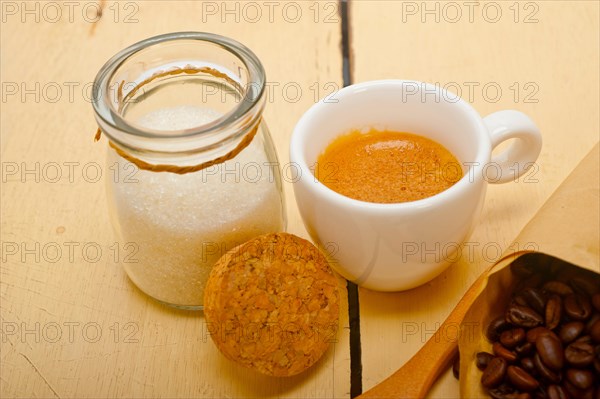 Espresso coffee and beans on a paper cone cornucopia over white background