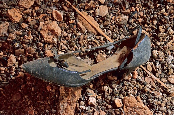 Black women's shoe with heel and bow at the bottom