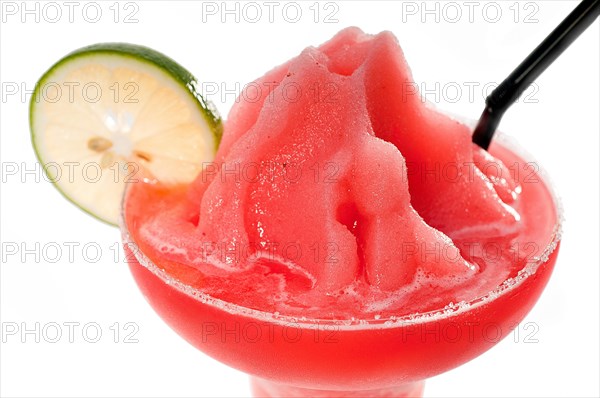 Frozen strawberry margarita daiquiri with lime and black straw isolated on white background