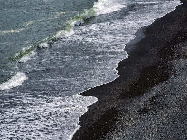Waves rolling on black lava beach Reynisfjara