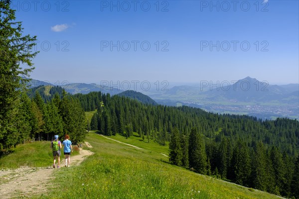 Hikers descending from the Weiherkopf peak near Bolsterlang