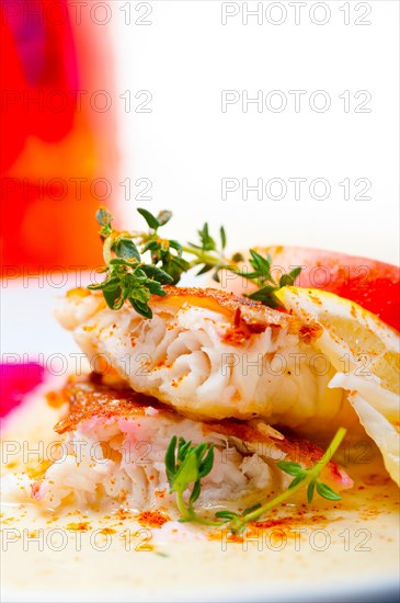 Sea bream orata fillet butter pan fried with fresh peach prune and dragonfruit slices thyme on top