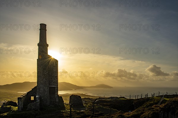 Old industrial plant backlit at golden hour