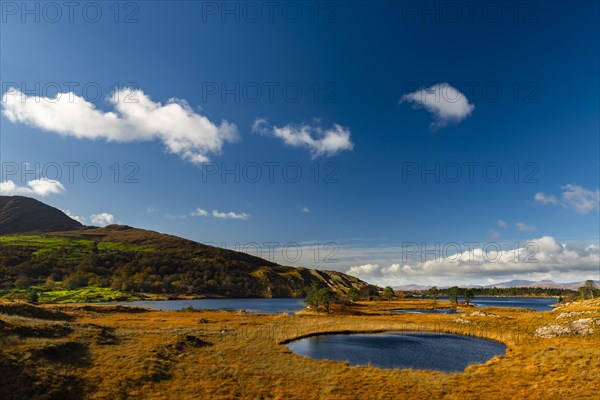Lough Cloonee with cloudy sky in autumn landscape