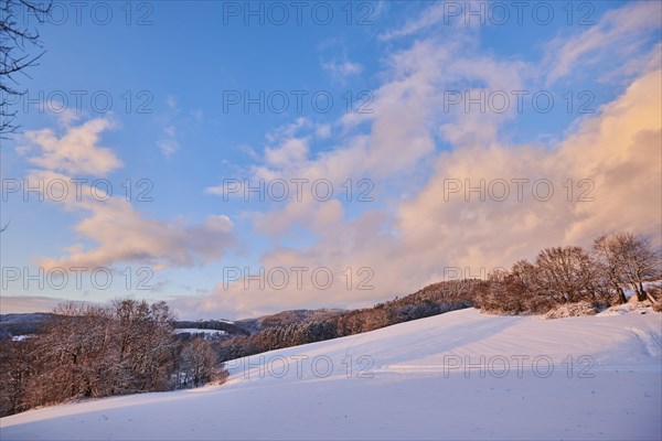 Colored Clouds over a field covered with snow near Wiesent