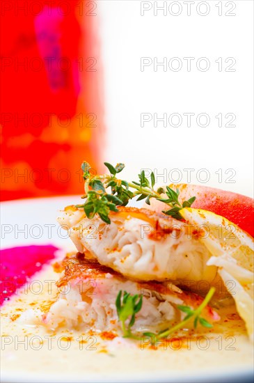 Sea bream orata fillet butter pan fried with fresh peach prune and dragonfruit slices thyme on top