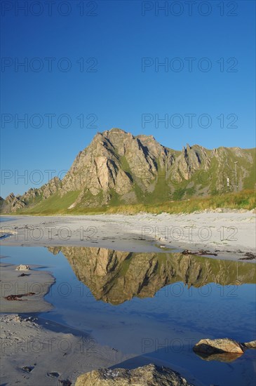 Mountains reflected in a small body of water