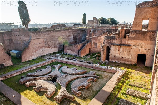 Ruin remains of ancient Pelta fountain in sunken peristyle former portico in former imperial palace Domus Augustana