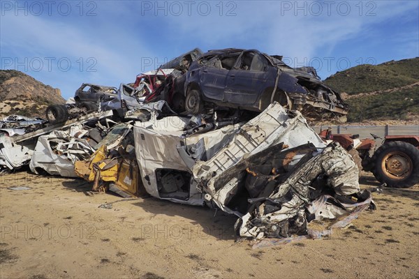 Scrapped and dented cars stacked on top of each other