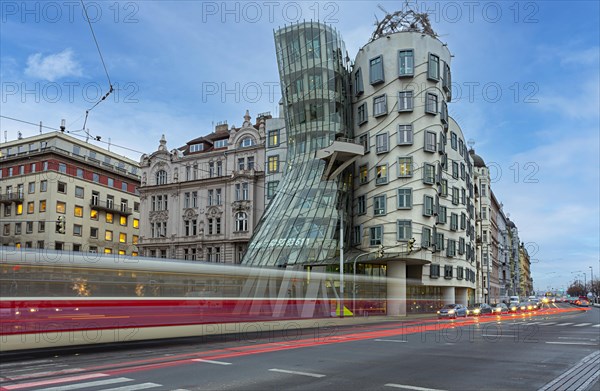 Moving tram in front of the dancing house