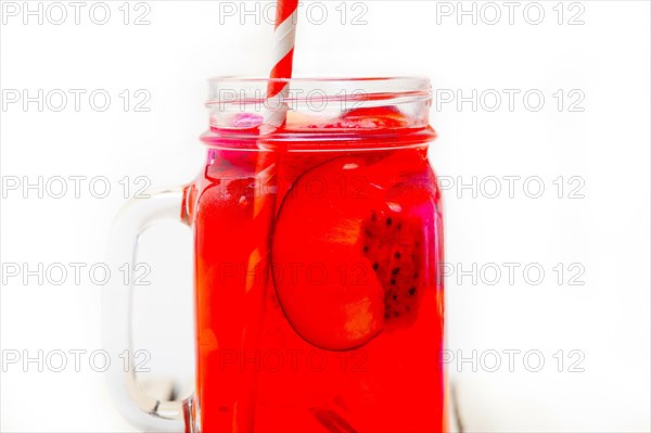 Fresh fruit punch refreshing summer drink over white rustic wood table