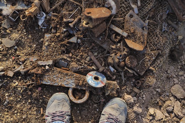 Feet in the middle of scrap piles