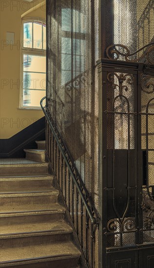 Ornate door from a historic lift in an old factory