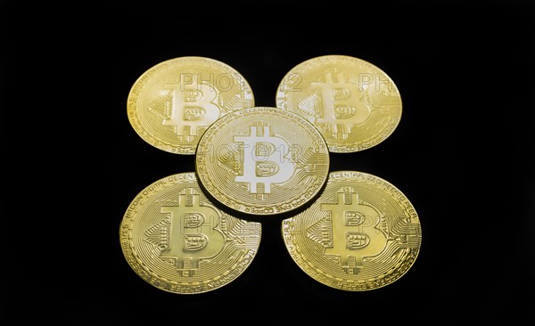 Bitcoin BTC crypto currency gold coins on black background