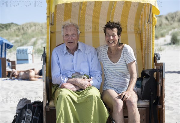 Tourists sitting in a beach chair