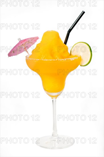 Frozen mango margarita daiquiri with lime black straw and pink umbrella isolated on white background