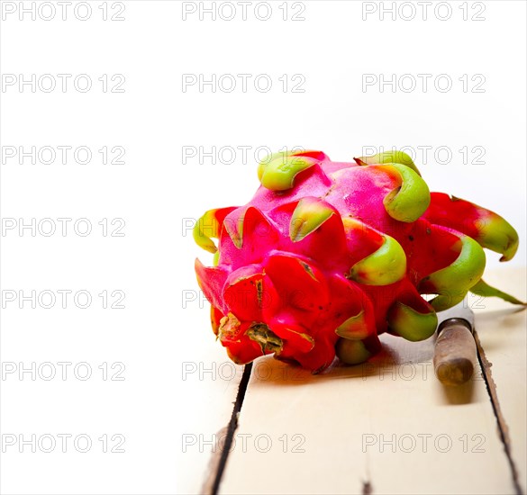 Fresh thai purple dragon fruit over white rustic table